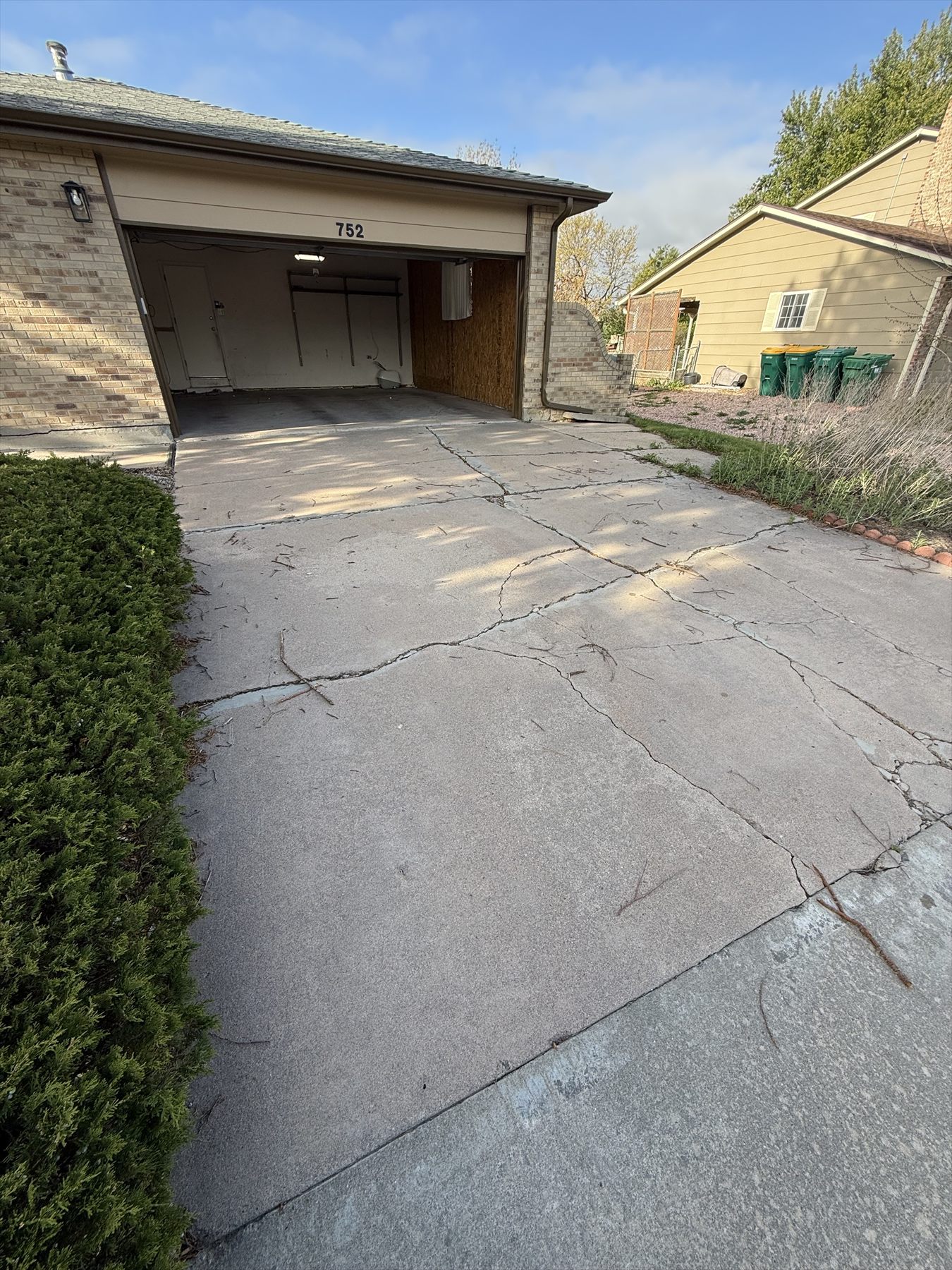 Cracked concrete driveway before replacement